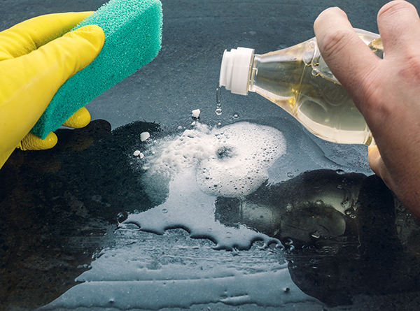 Image of a person cleaning with household products