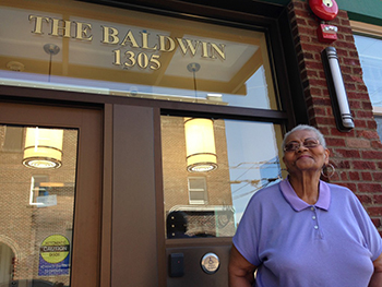 Woman standing in front of The Baldwin residential building