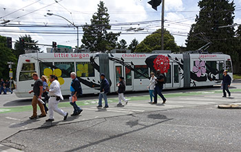 People walking as streetcar passes