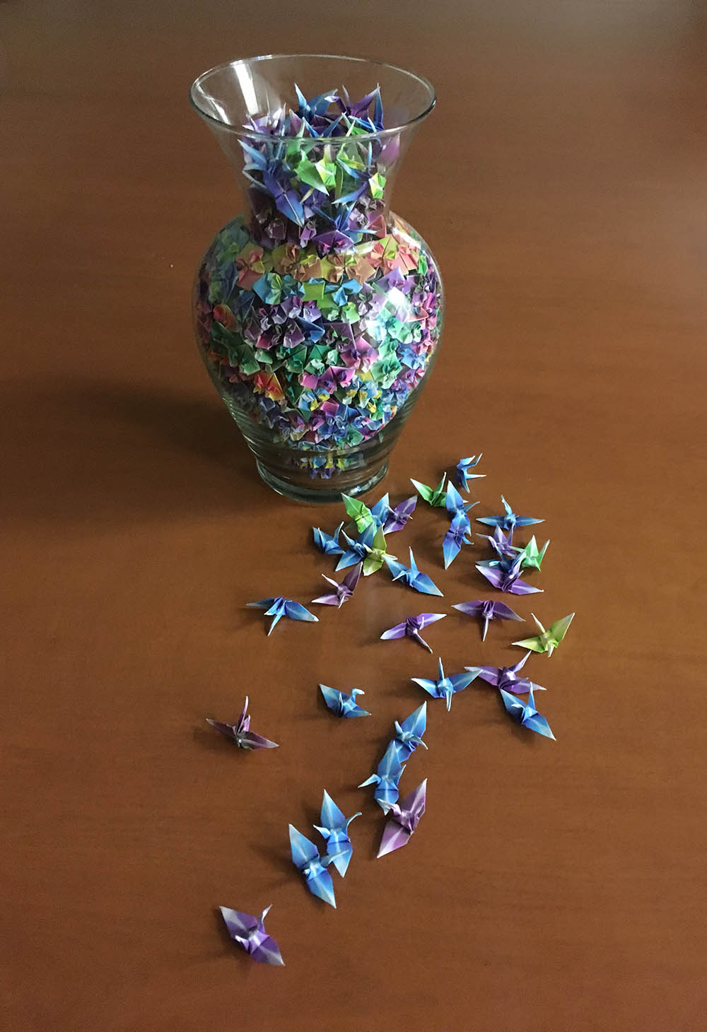 Origami cranes in a vase and on table