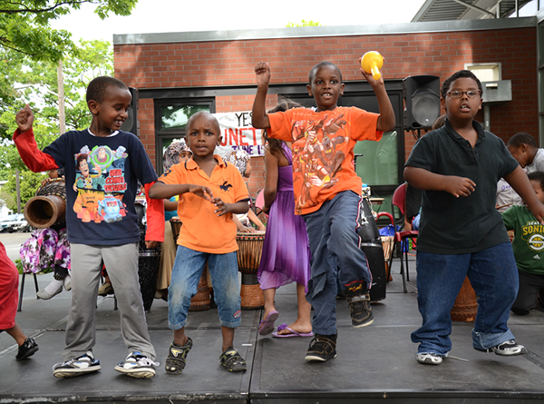 Kids dancing in front of community center building