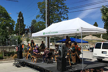 Band playing outdoors under a canopy