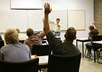 Man raises hand in classroom