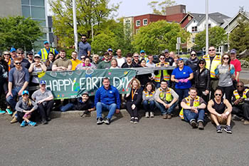 Earth Day volunteers holding banner