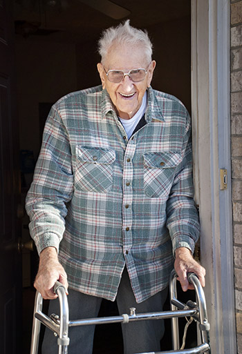 Elderly man using a walker