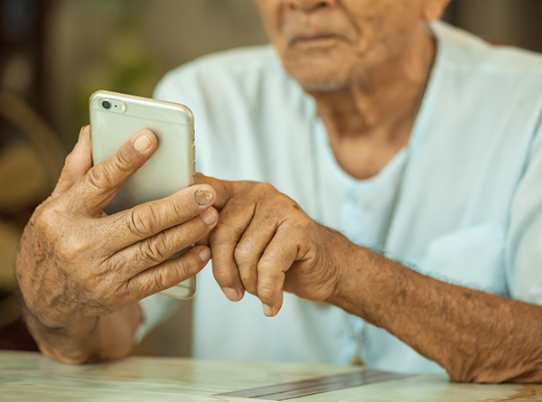 Elderly man using smart phone