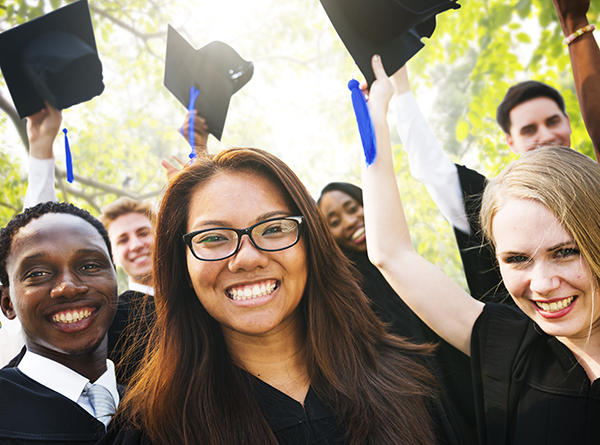 Group of young people wearing caps and gowns