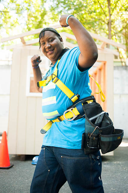 Woman holding arms up in show of strength