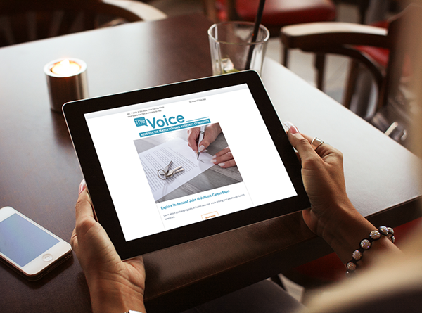 Woman's hands holding iPad with The Voice newsletter displayed on it