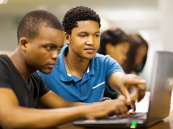 Two boys using laptop computer