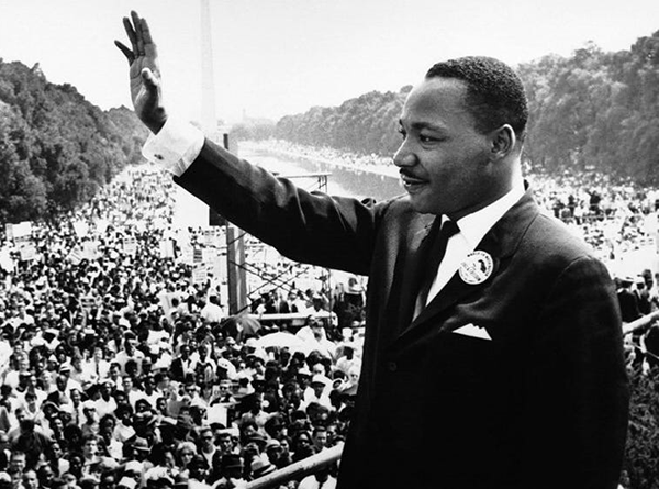 Martin Luther King Jr. waving at crowds during 1963 Civil Rights March in Washington D.C.