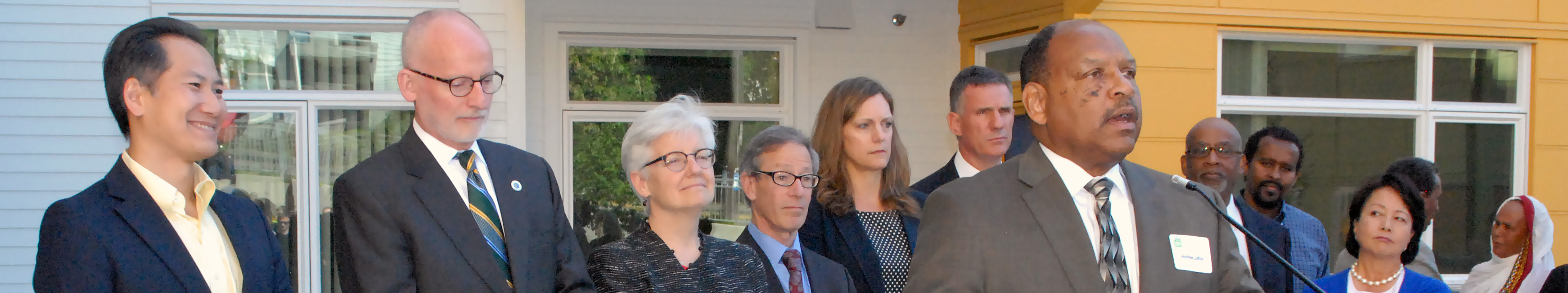 People standing in front of podium in a community setting