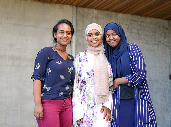 Hermella, Khadra and Muna, scholarship recipients, standing together