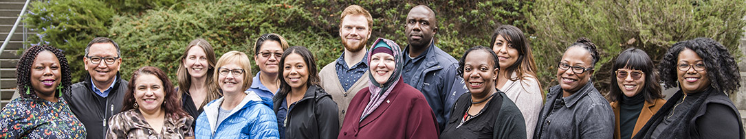 Group of people standing together with trees in background