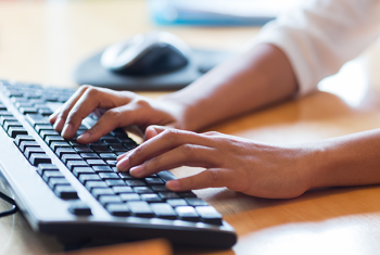 Person typing on keyboard