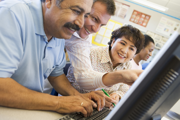 Image of people getting help with computer