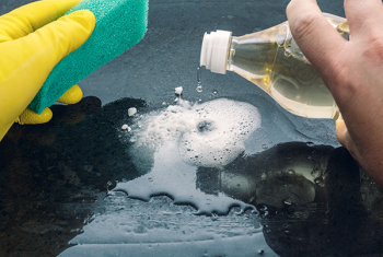 Image of a person cleaning with household products