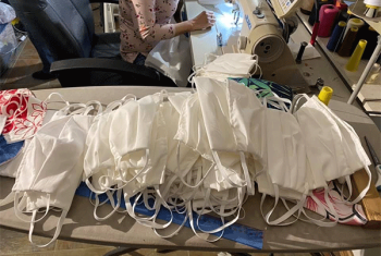 Stack of sewn cloth face masks on table