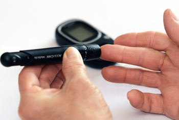 Hands hold glucose meter