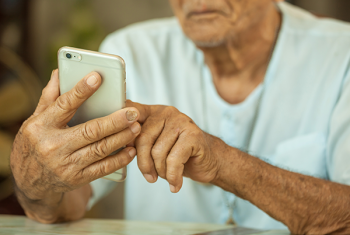Elderly man using smart phone