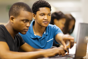 Two boys using laptop computer