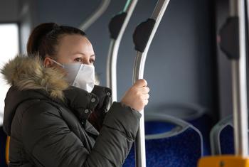 Woman on public transit wearing mask
