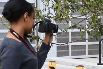 Young filmmaker holding camera