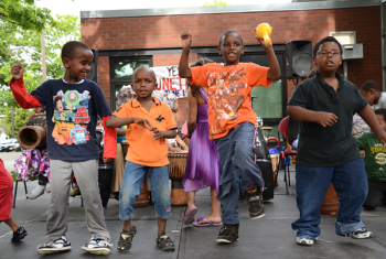 Kids dancing in front of community center building