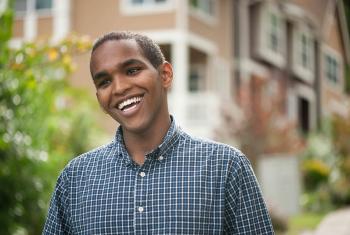 Young man with houses in background