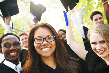Group of young people wearing caps and gowns