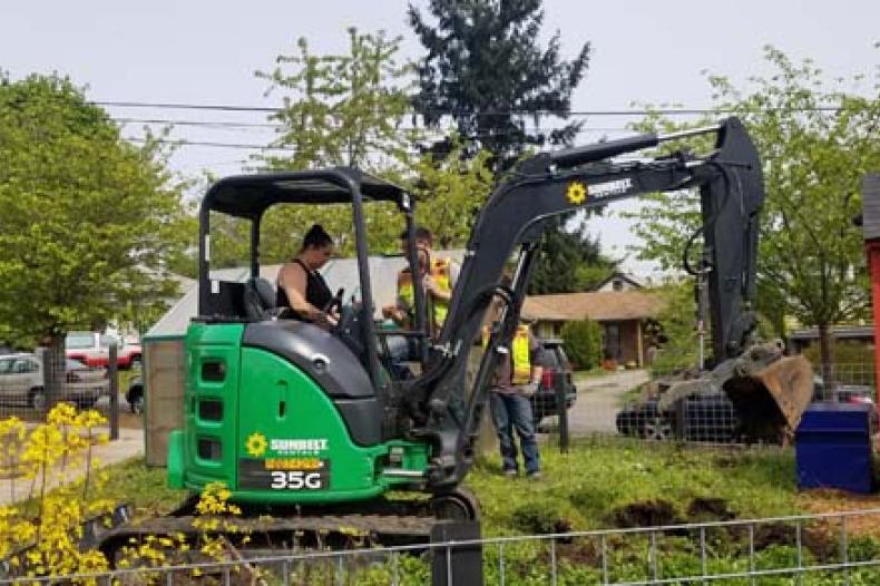 Woman operates dump shovel