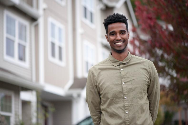 Young man standing in front of a building