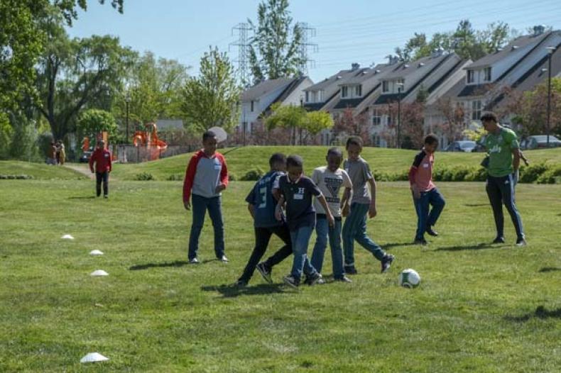 Boys play soccer on field