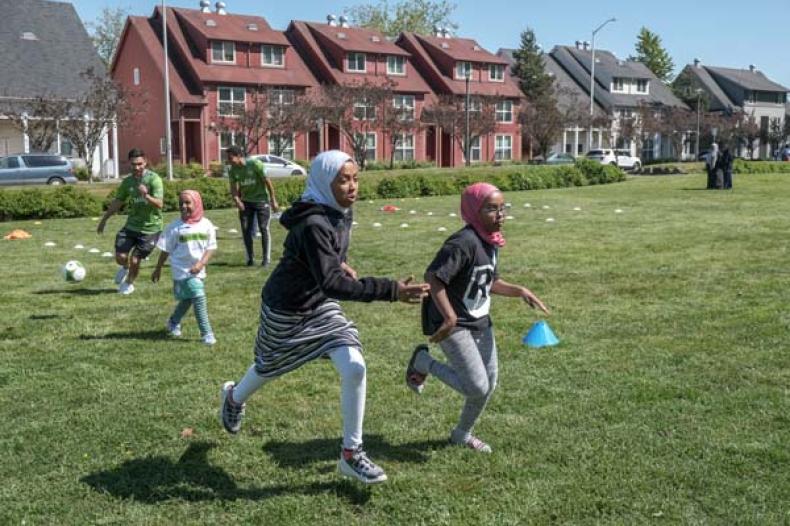 Girls and boys running on a field