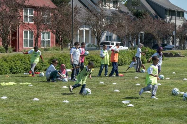 Kids standing, sitting or running on field