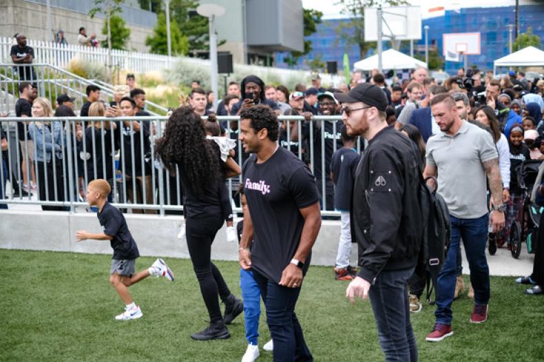 Russell Wilson steps on RAVE Field at Yesler Park for RAVE Foundation event