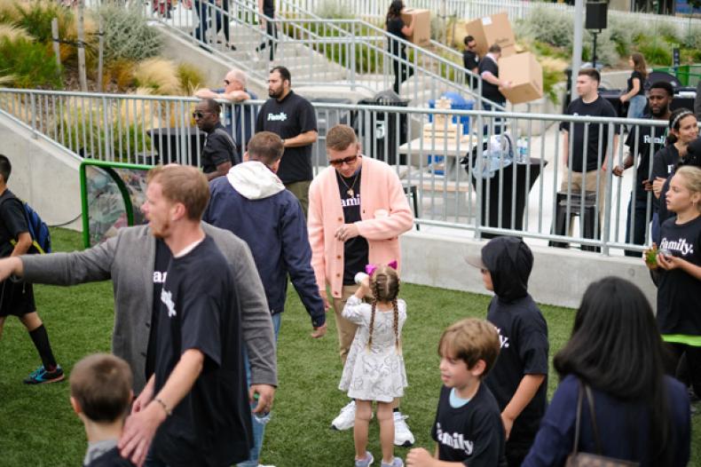 Group of people standing on soccer field