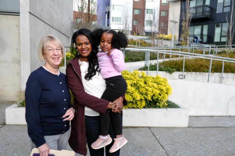 Senator Patty Murray with woman and young child outside at Yesler