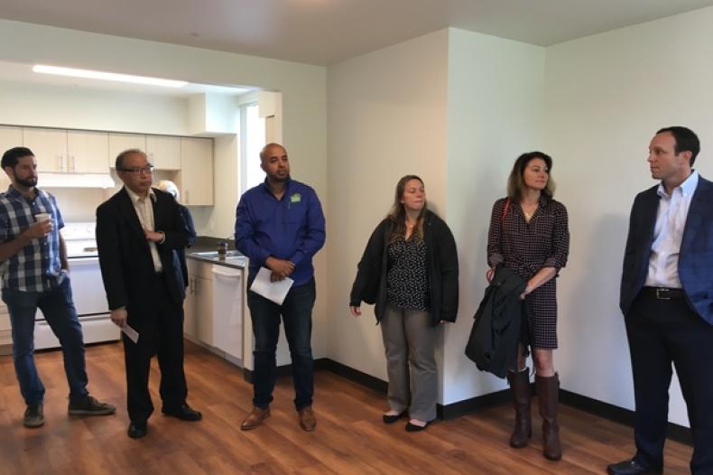 People viewing the interior of an apartment unit