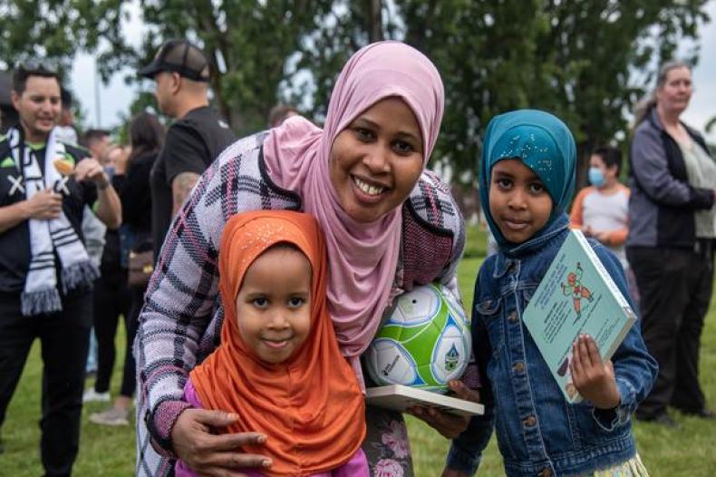 Image of two young children with their mother