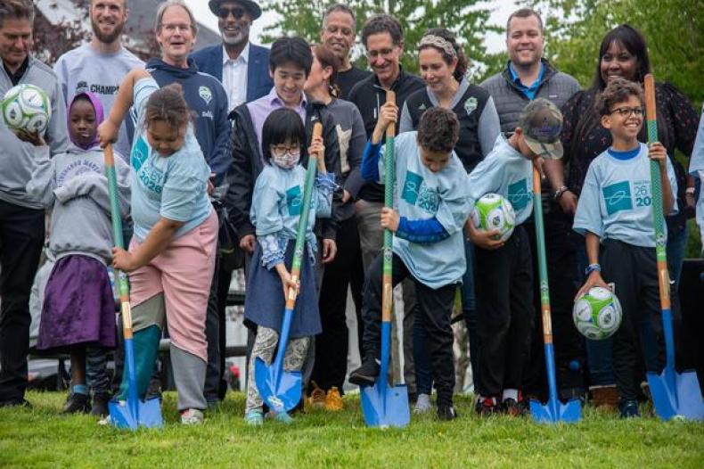 Group image of children holding shovels pictured with SHA Executive Director Rod Brandon, Brad Evans, Adrian Hanauer, Thach Nguyen, Brian Schmetzer
