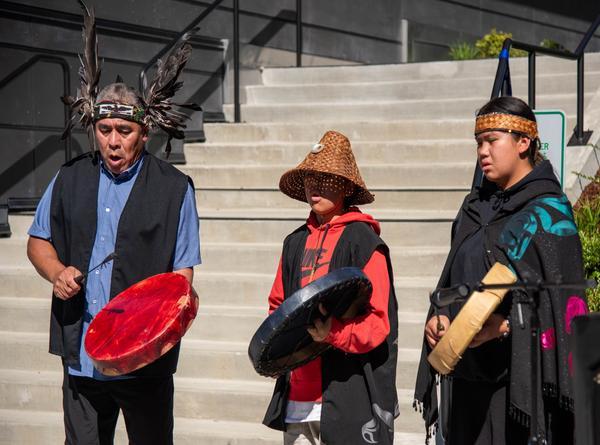 Performers John Etzel, Native name YEXPILEM,  his son Heli Etzel, Native name KÁNTELÁNEW̱, and granddaughter, Jordyn Seymour, Native name TELÁNEW̱OT, from theTSAWOUT First Nation people of British Columbia