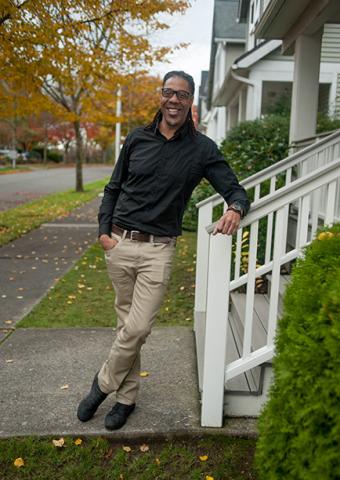 Man leans against a building railing
