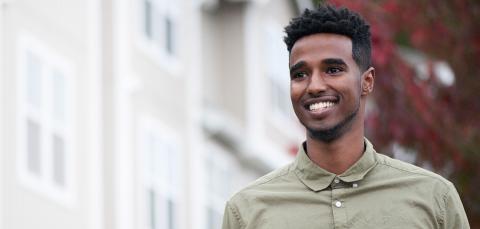 Young man standing in front of building