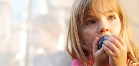 child eating fruit