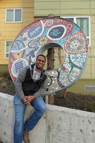 Yeggy Michael and sculpture he created at Kebero Court