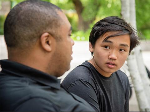 Young man and teen sitting and talking