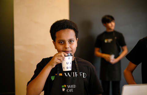 Teenage boy sips coffee
