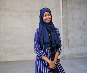 Muna standing and smiling