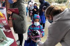Small boy receives soccer ball at RAVE Foundation Books and Balls event